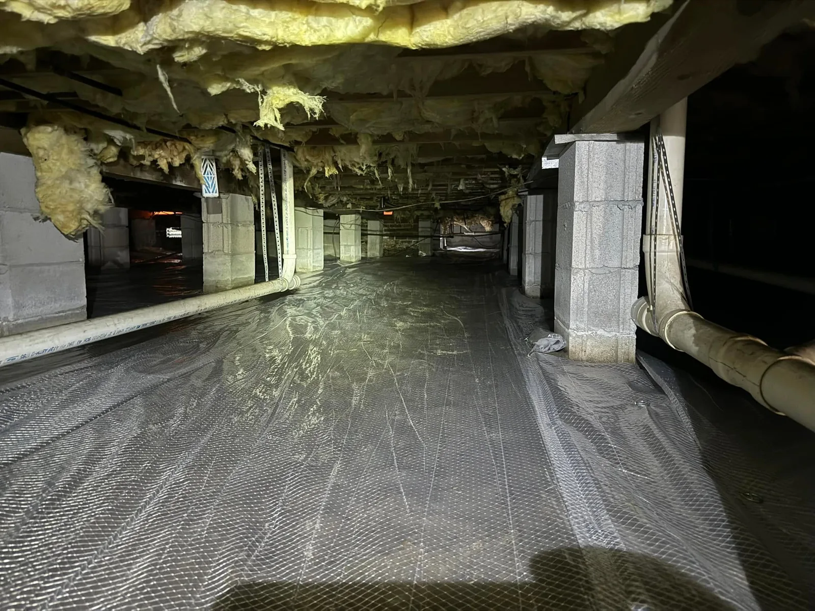 A vapor barrier installed by Beagle Services beneath a home
